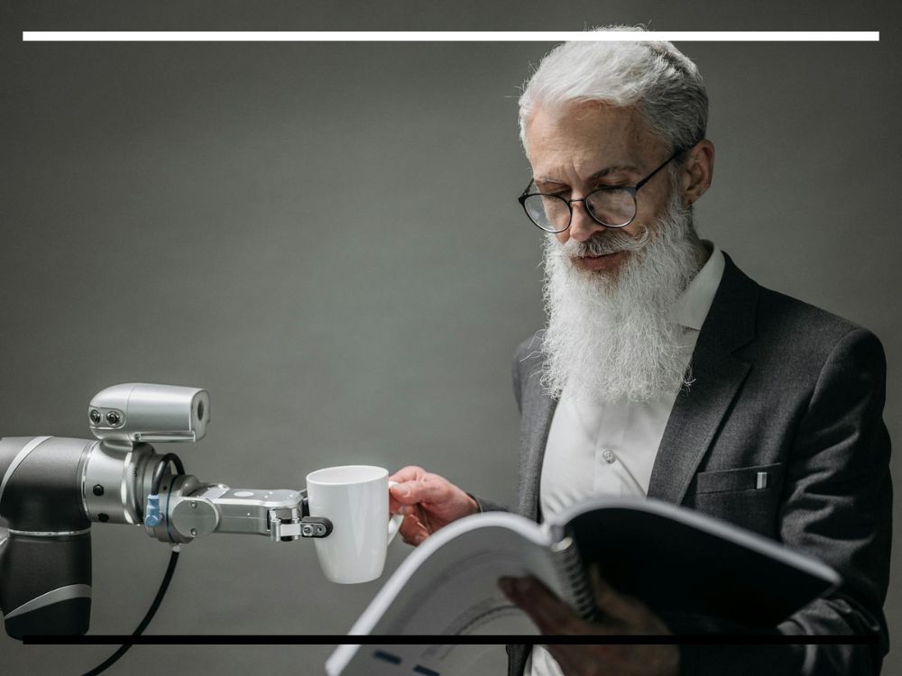 Robô servindo uma xícara de café para um homem de barba branca que lê um documento, simbolizando a relação entre inteligência artificial e trabalho humano