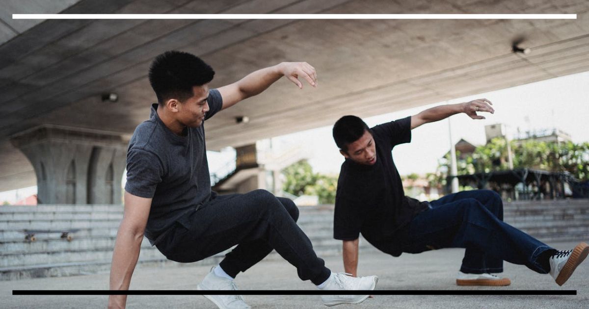 Dois homens dançando de forma sincronizada sob um viaduto, simbolizando a psicomotricidade como integração entre corpo, mente e emoção.
