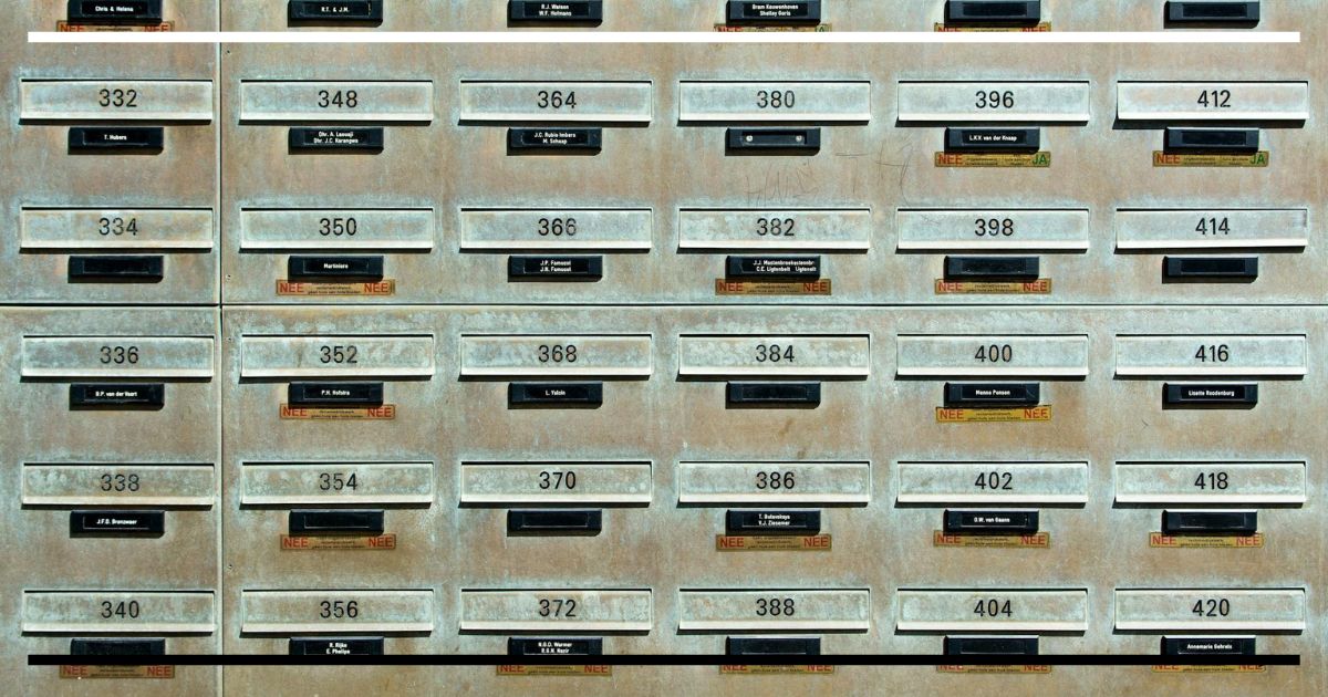 Matriz de gavetas metálicas numeradas, alinhadas em grade, com janelas de etiqueta – aparência de arquivo antigo.